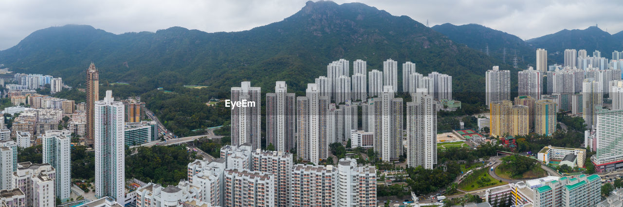 Panoramic shot of modern buildings in city against sky