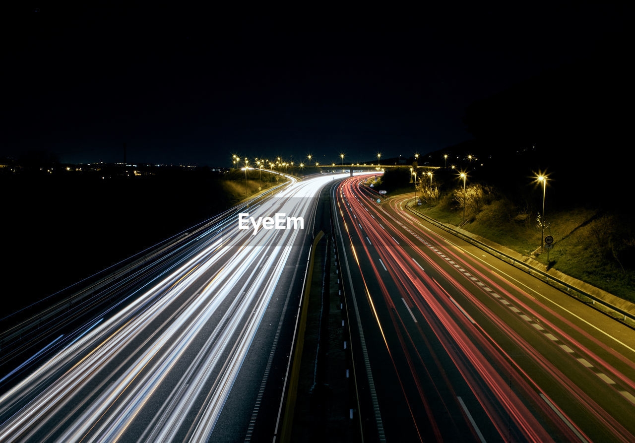 High angle view of light trails on road at night