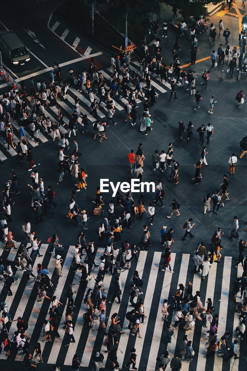 High angle view of people walking on road in city