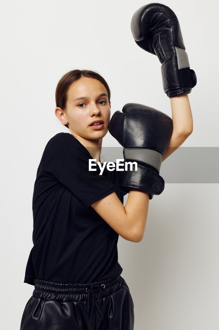 Portrait of teenager girl wearing boxing gloves