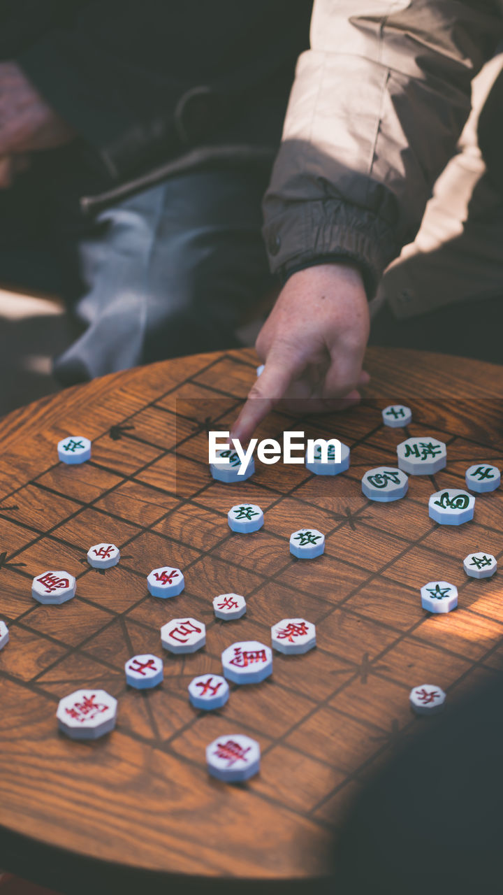 Midsection of friends playing board game