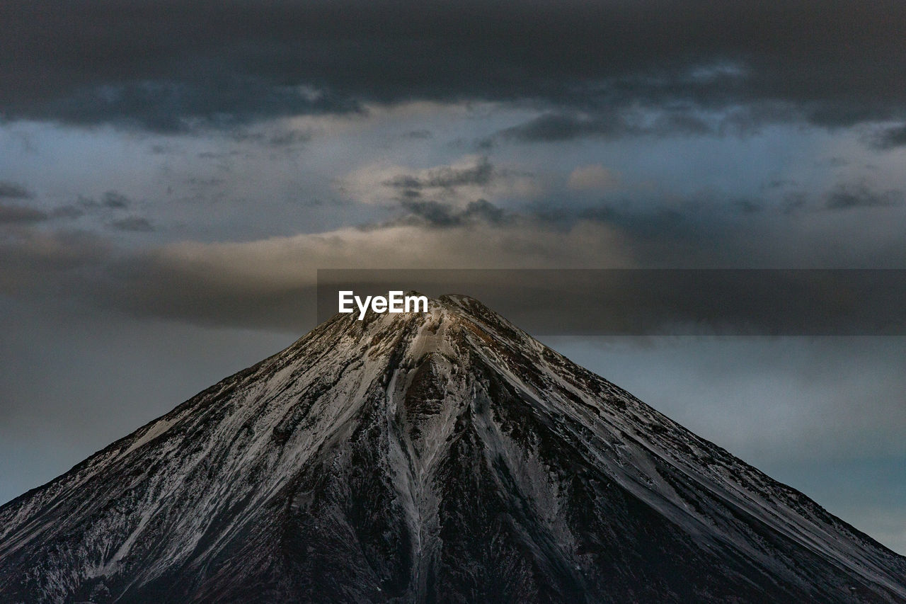 Low angle view of snowcapped mountain against sky