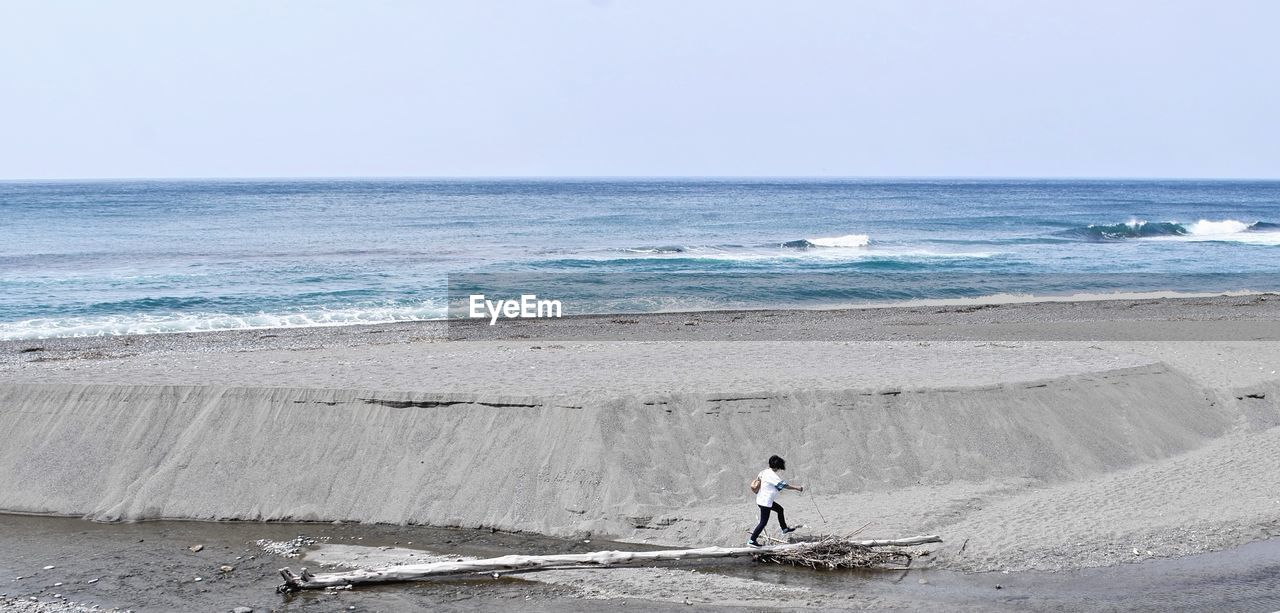 Full length of man on beach against sky