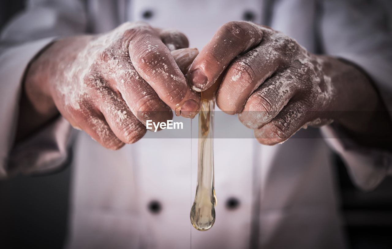 Close-up midsection of chef pouring egg white