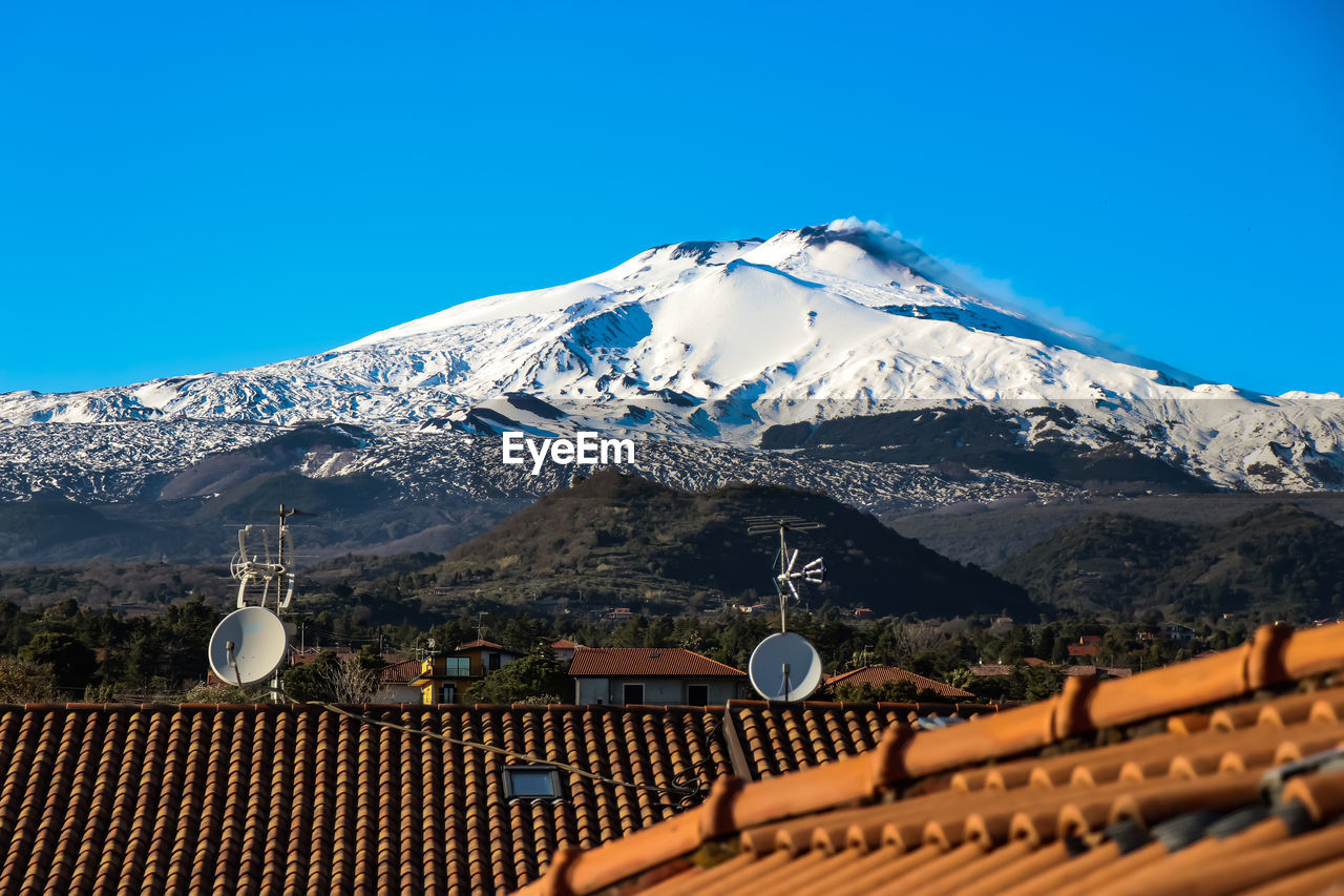 Scenic view of snowcapped mountains against clear blue sky