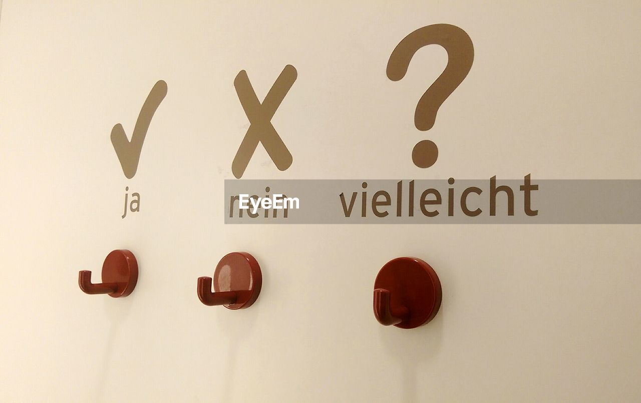 Hooks on wall with text
