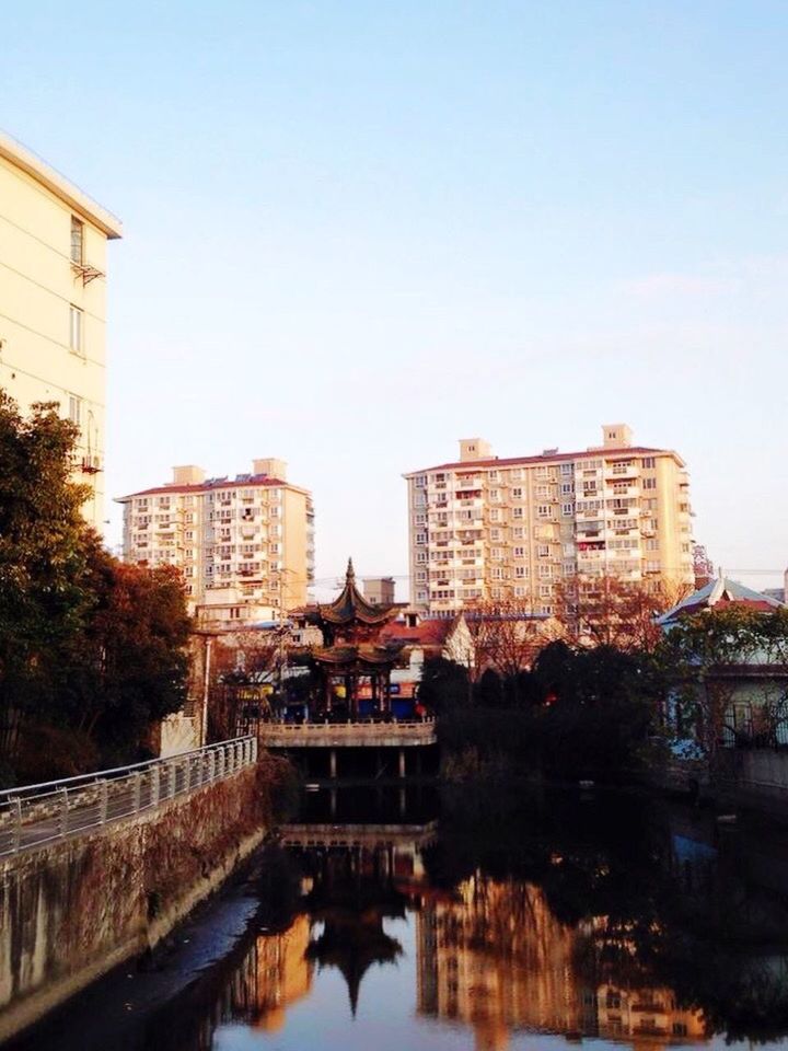 VIEW OF RIVER WITH BUILDINGS IN BACKGROUND