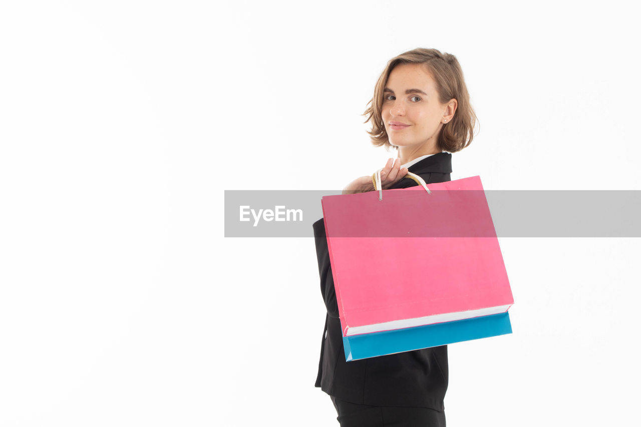 PORTRAIT OF A YOUNG WOMAN AGAINST WHITE BACKGROUND