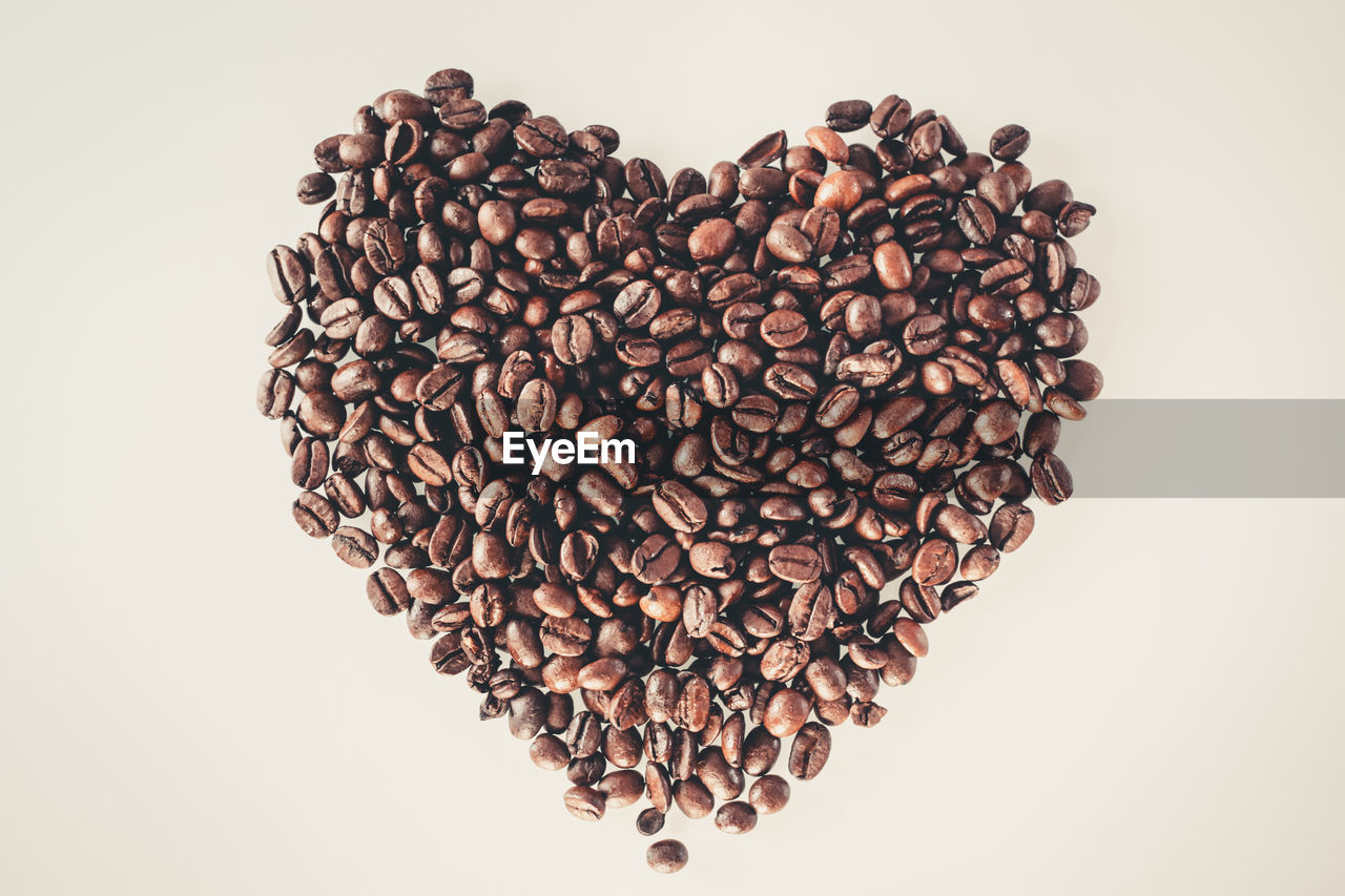 Coffee beans in a heart shape on a bright surface
