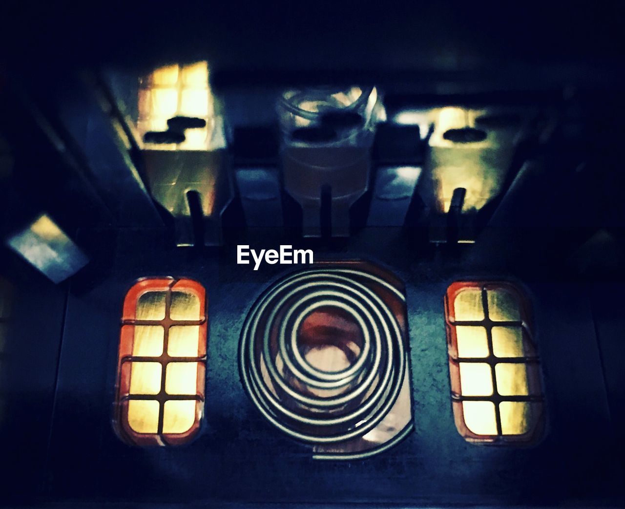 CLOSE-UP OF ILLUMINATED LIGHTS IN KITCHEN