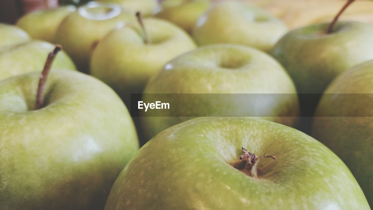 Full frame shot of granny smith apples for sale at store