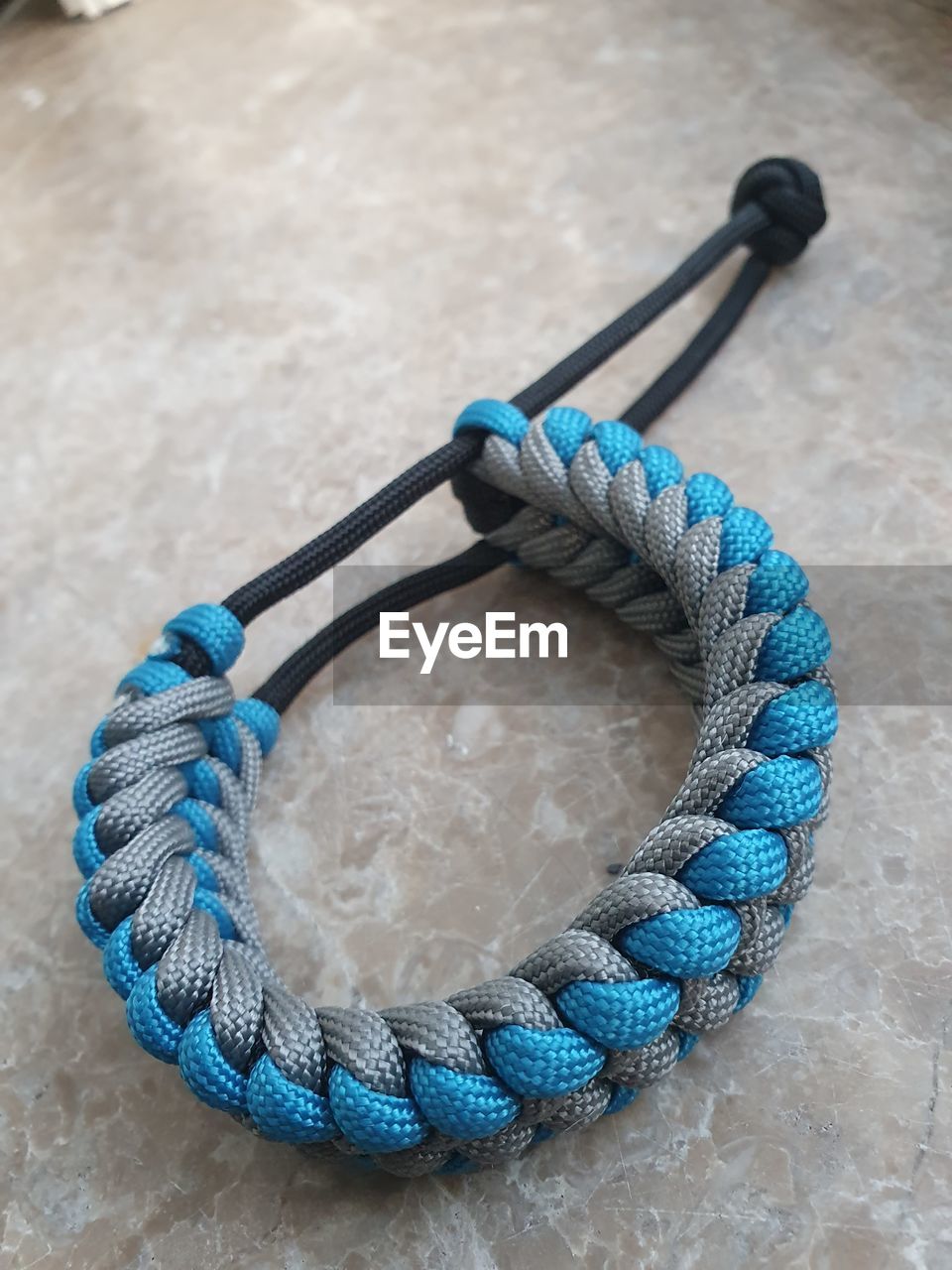 HIGH ANGLE VIEW OF ROPE ON BLUE TABLE