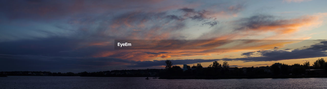 SCENIC VIEW OF SILHOUETTE BUILDING AGAINST ORANGE SKY