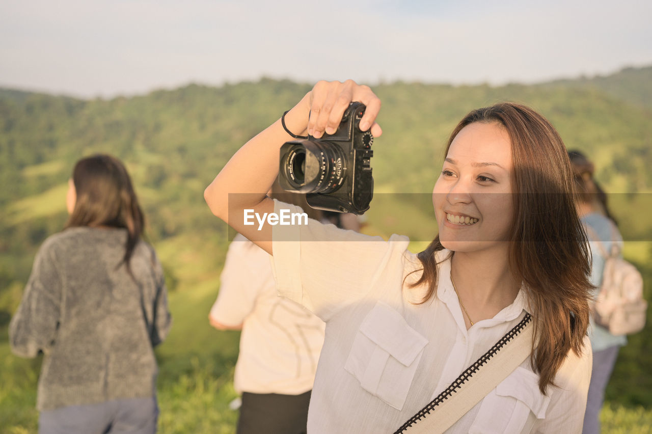 Happy young woman enjoy with her camera