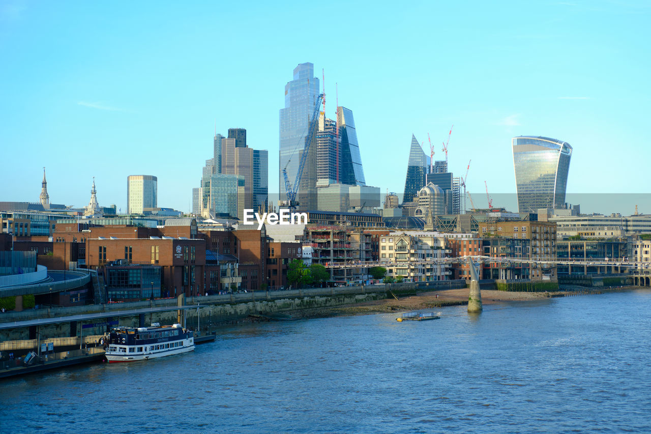 London city skyline and river thames viewed from blackfriars station. afternoon with clear blue sky.