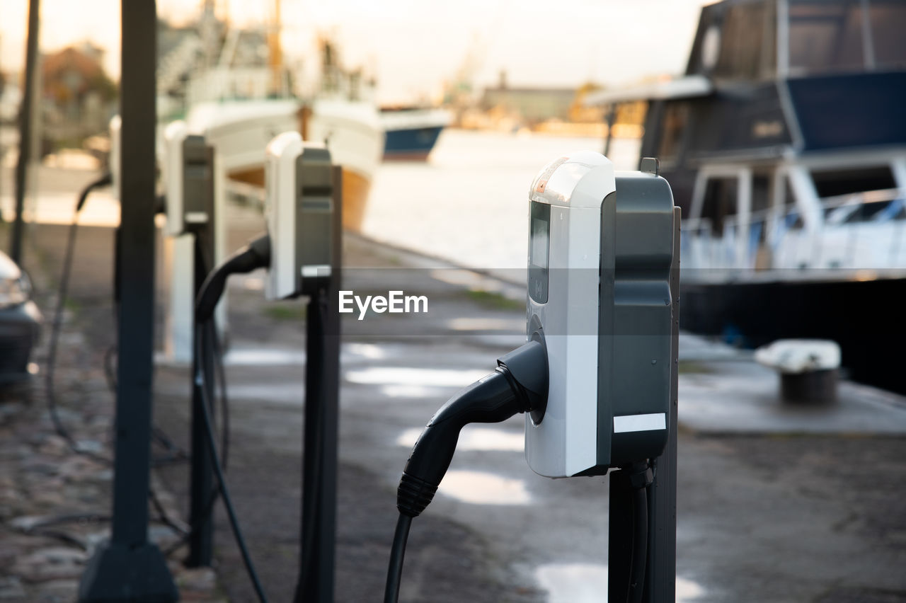 Electric car charging station next to the port. car charging next to the water.