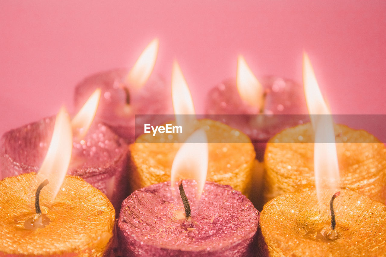 close-up of illuminated candles on table