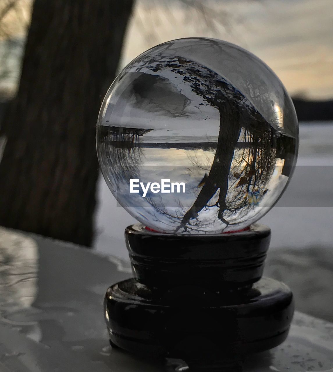 CLOSE-UP OF CRYSTAL BALL WITH REFLECTION ON GLASS