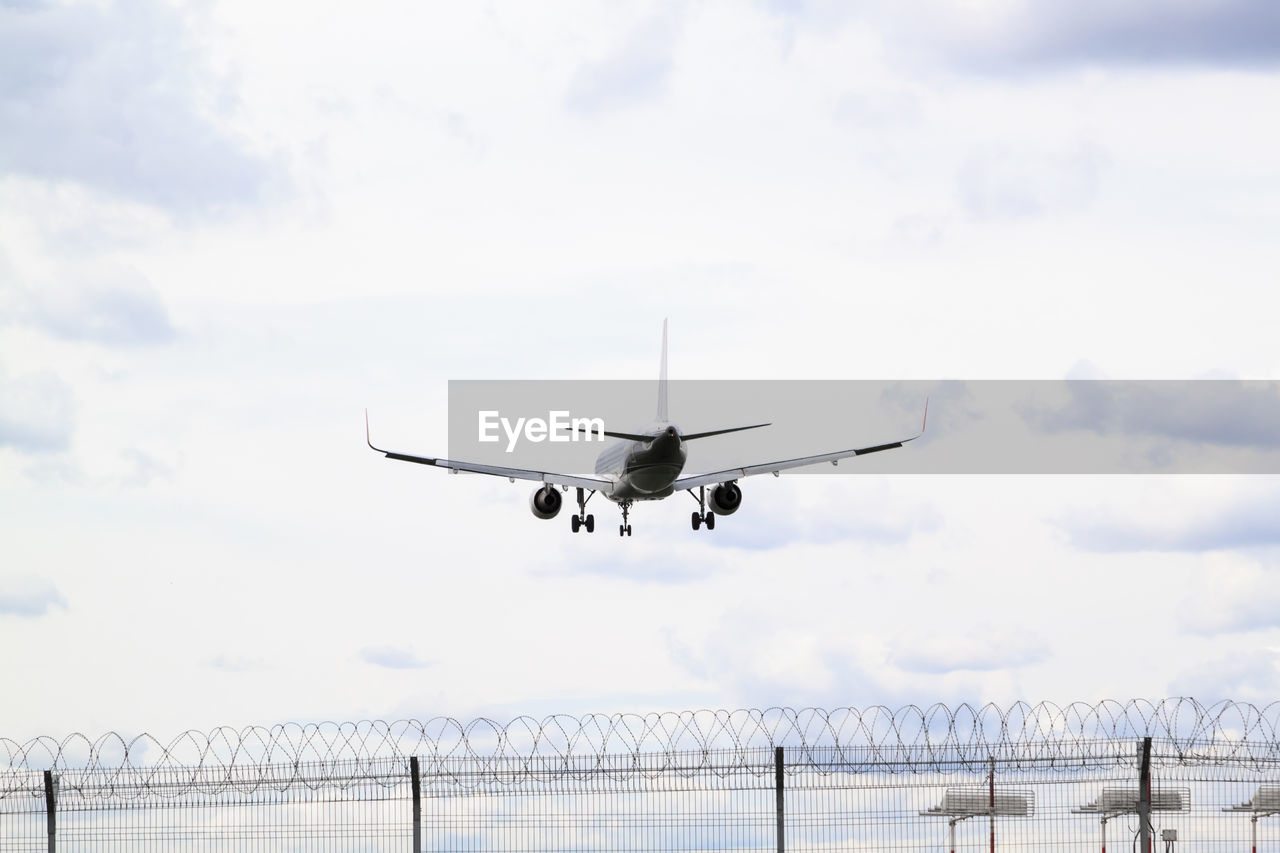 LOW ANGLE VIEW OF AIRPLANE AGAINST SKY