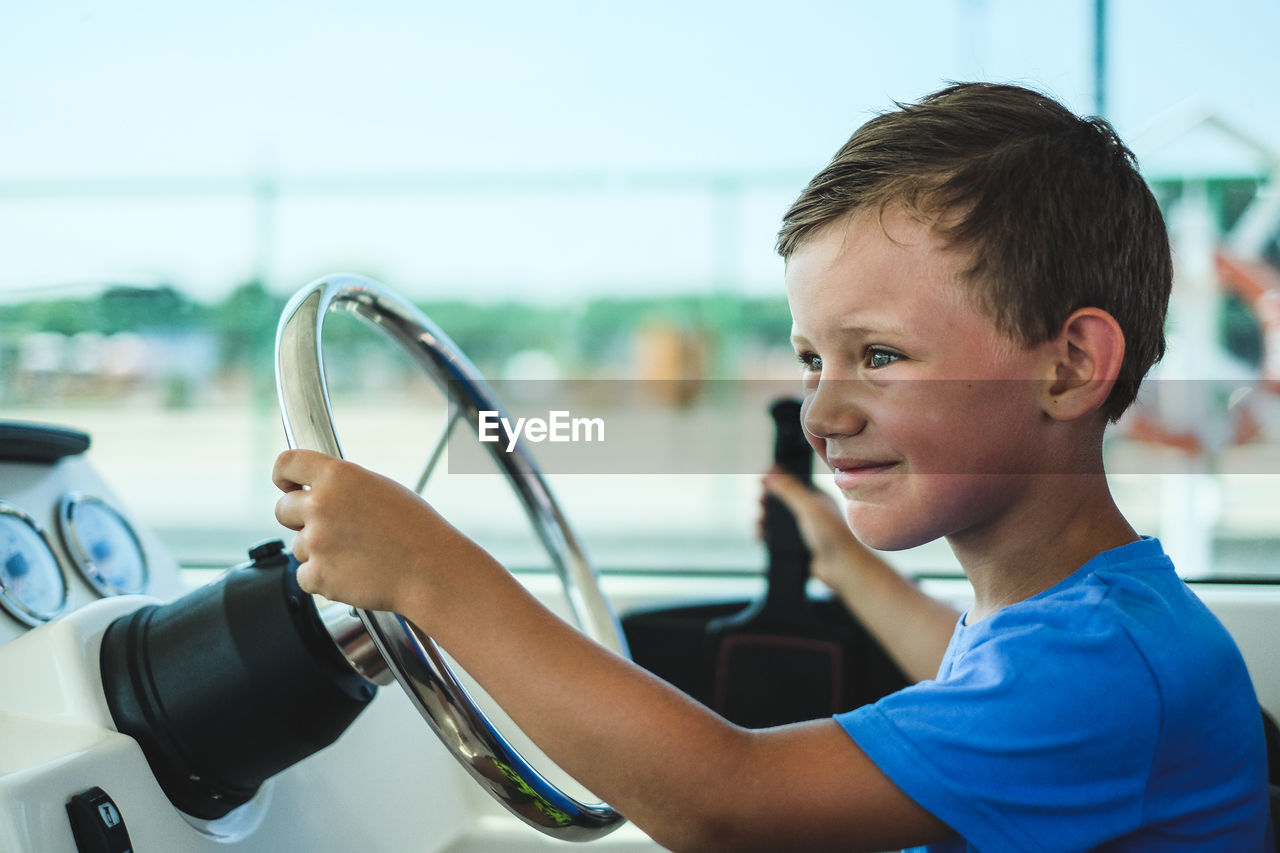 Boy sitting in car