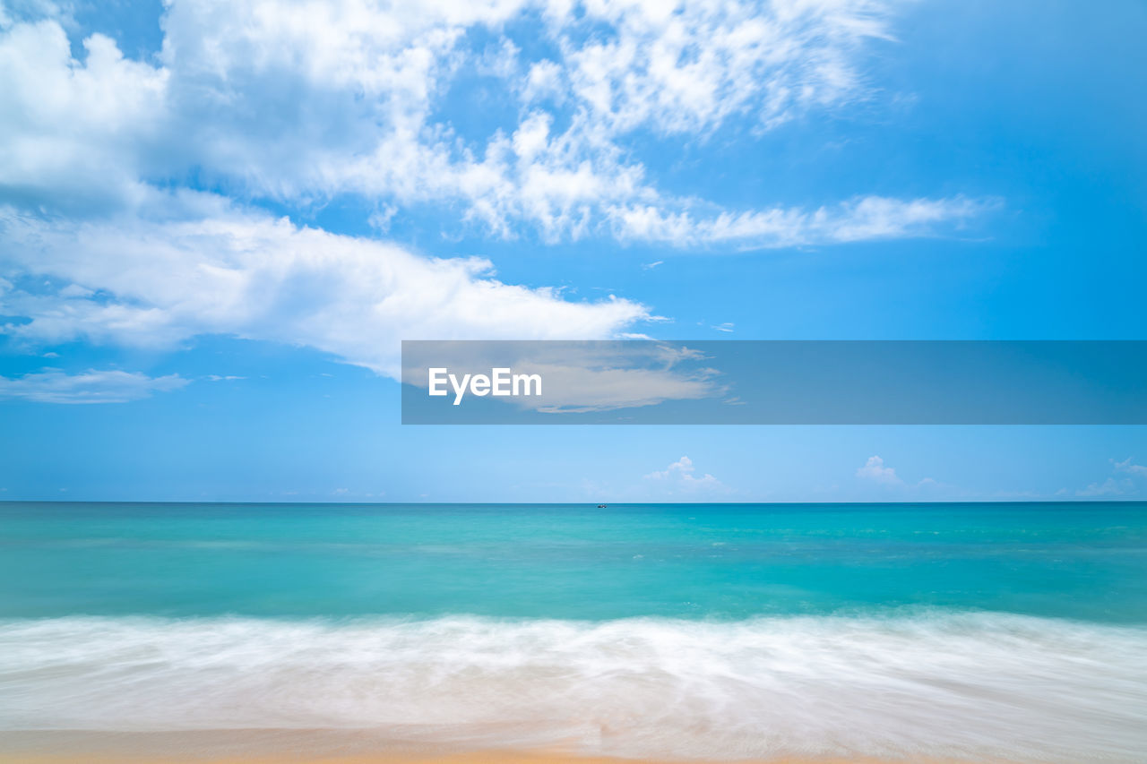 Seascape of soft wave in tropical sea and sandy beach blue cloud sky. 