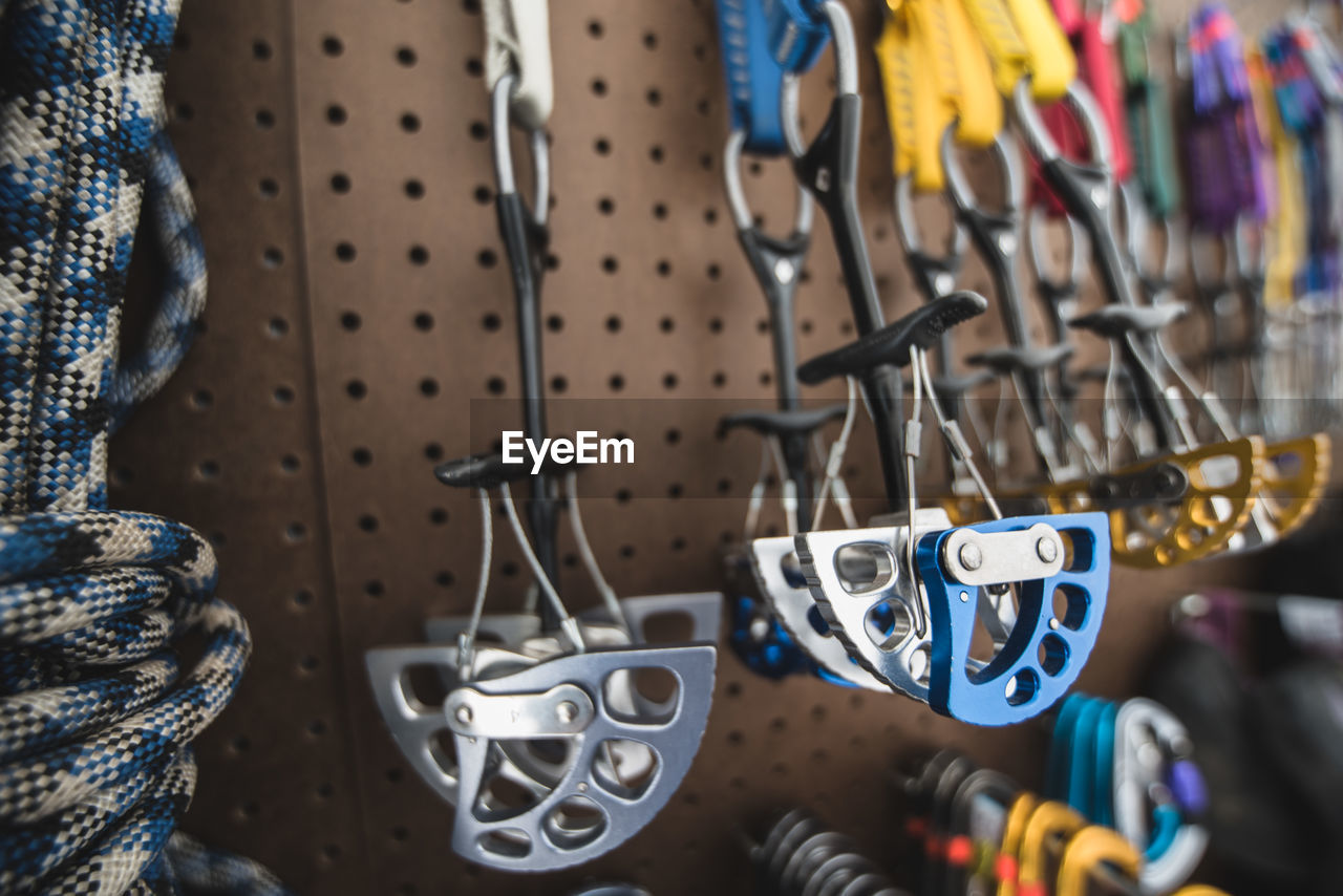 Close-up of multi colored safety harness hanging in store for sale