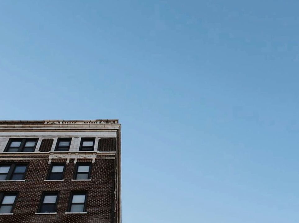 LOW ANGLE VIEW OF BUILDINGS AGAINST CLEAR SKY