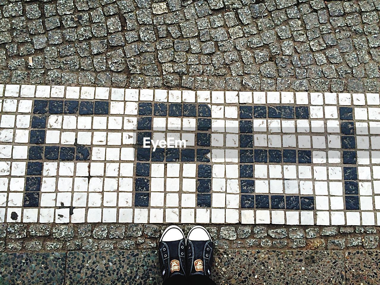 Man standing by marking on ground showing frei