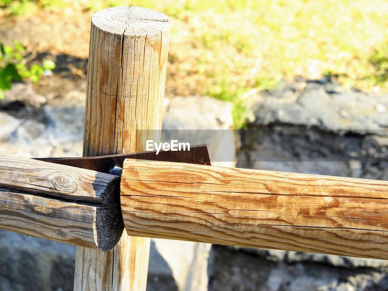 Close-up of wooden post on log