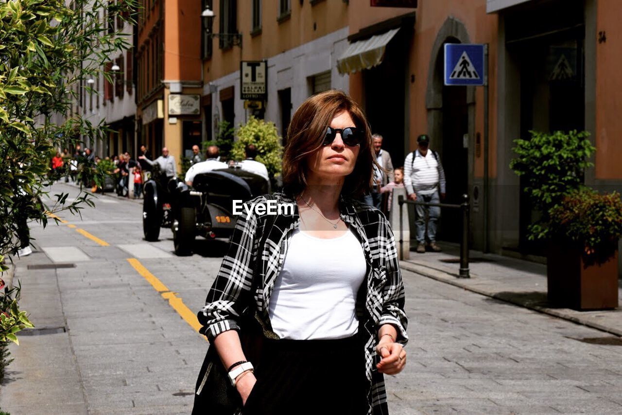 Woman walking on street in city