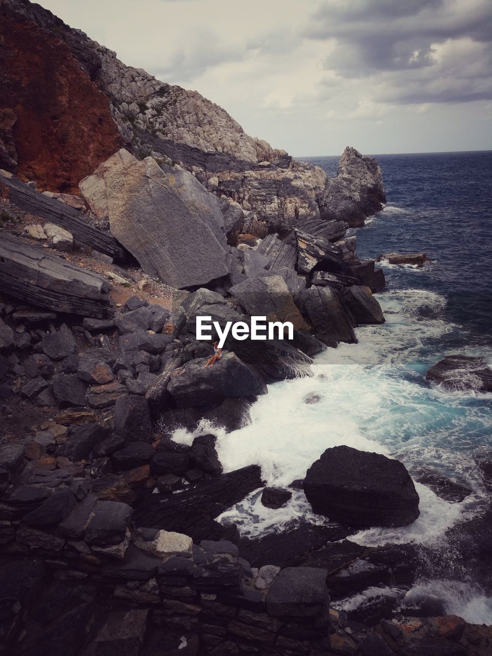 ROCKS ON BEACH AGAINST SKY