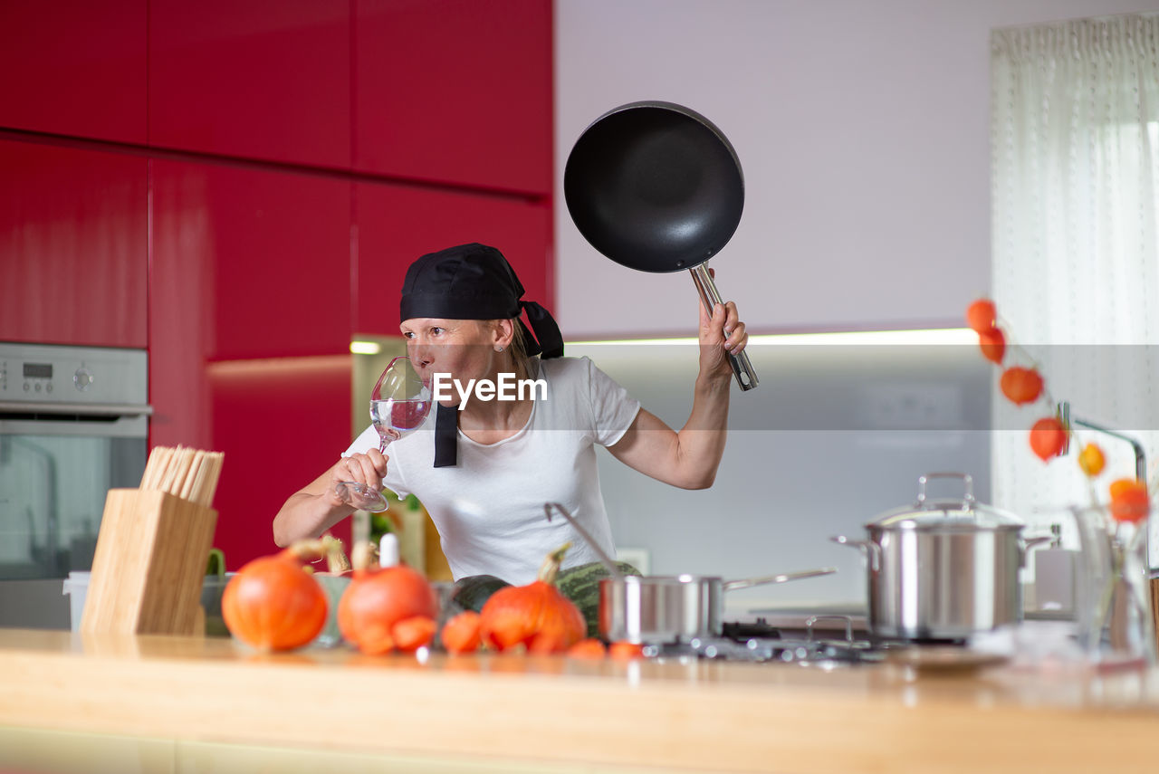 MAN PREPARING FOOD AT HOME