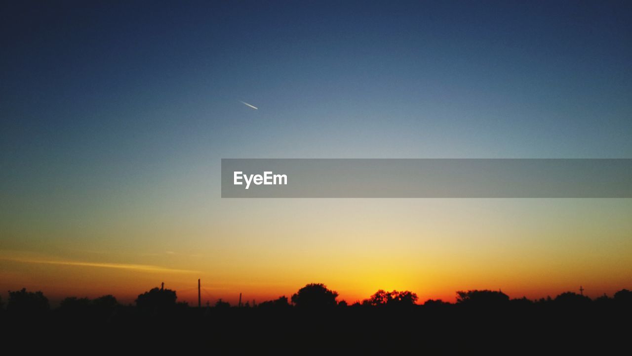 SILHOUETTE LANDSCAPE AGAINST SKY DURING SUNSET