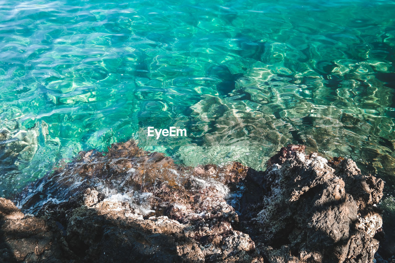 High angle view of rocks in sea