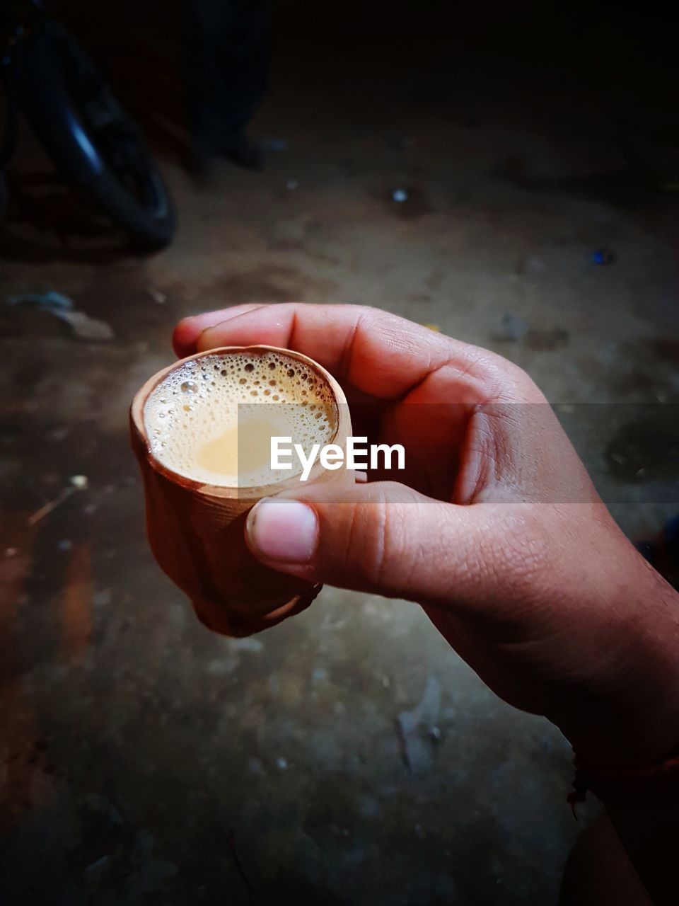 Cropped image of hand holding chai