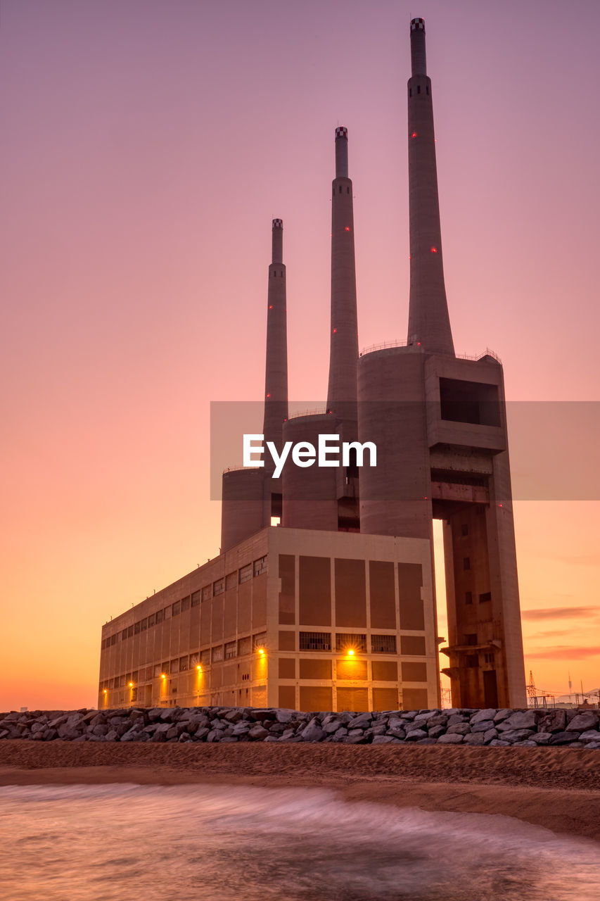 The disused thermal power station at sand adria near barcelona at sunset