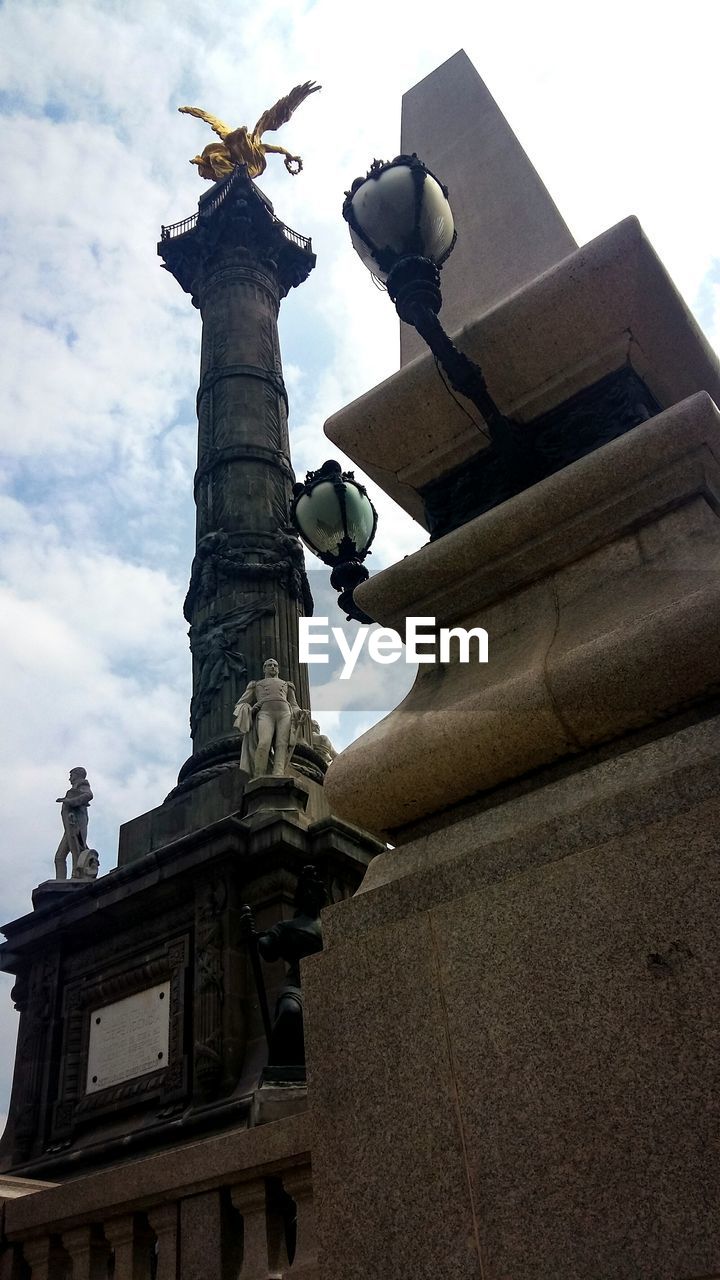 LOW ANGLE VIEW OF STATUES AGAINST SKY