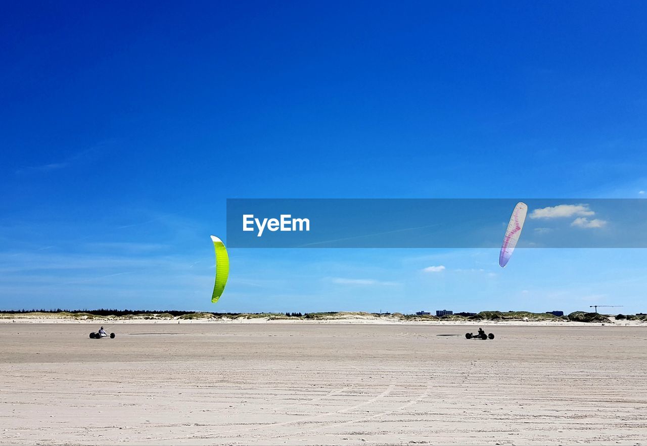 Umbrella on beach against blue sky