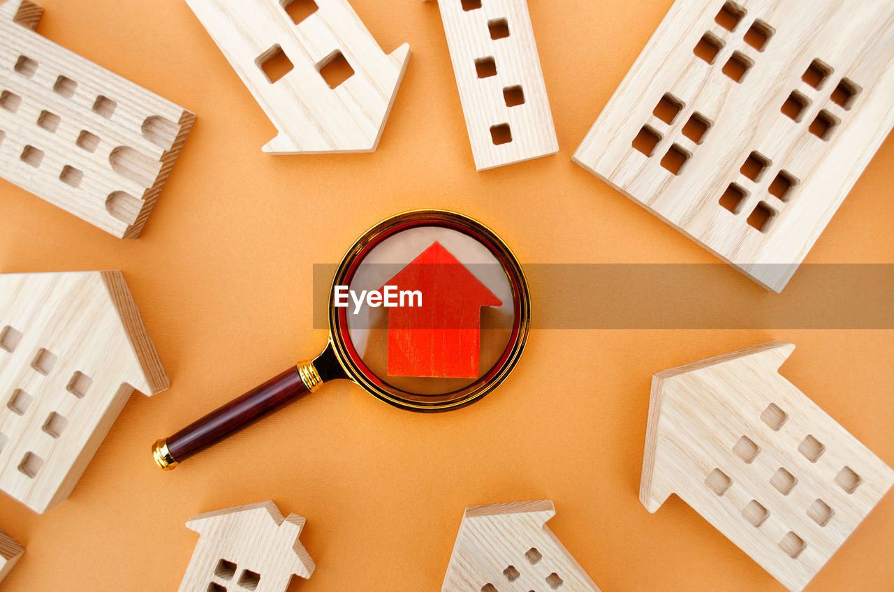 Magnifying glass and wooden houses. house searching concept. home appraisal. 