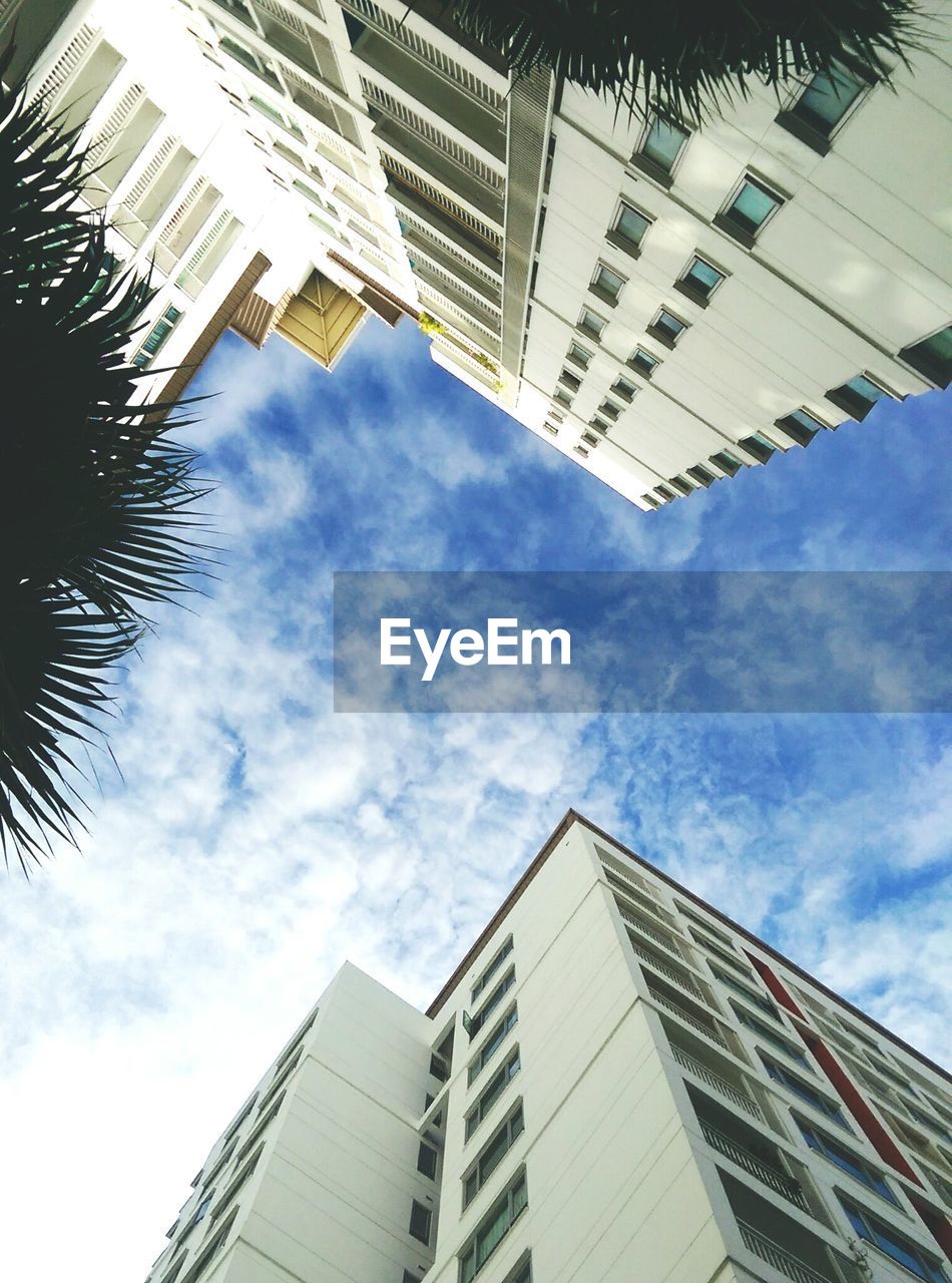 Directly below shot of buildings against sky