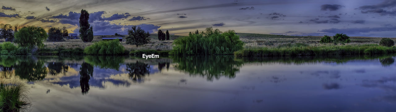 Panoramic shot of river against sky during sunset