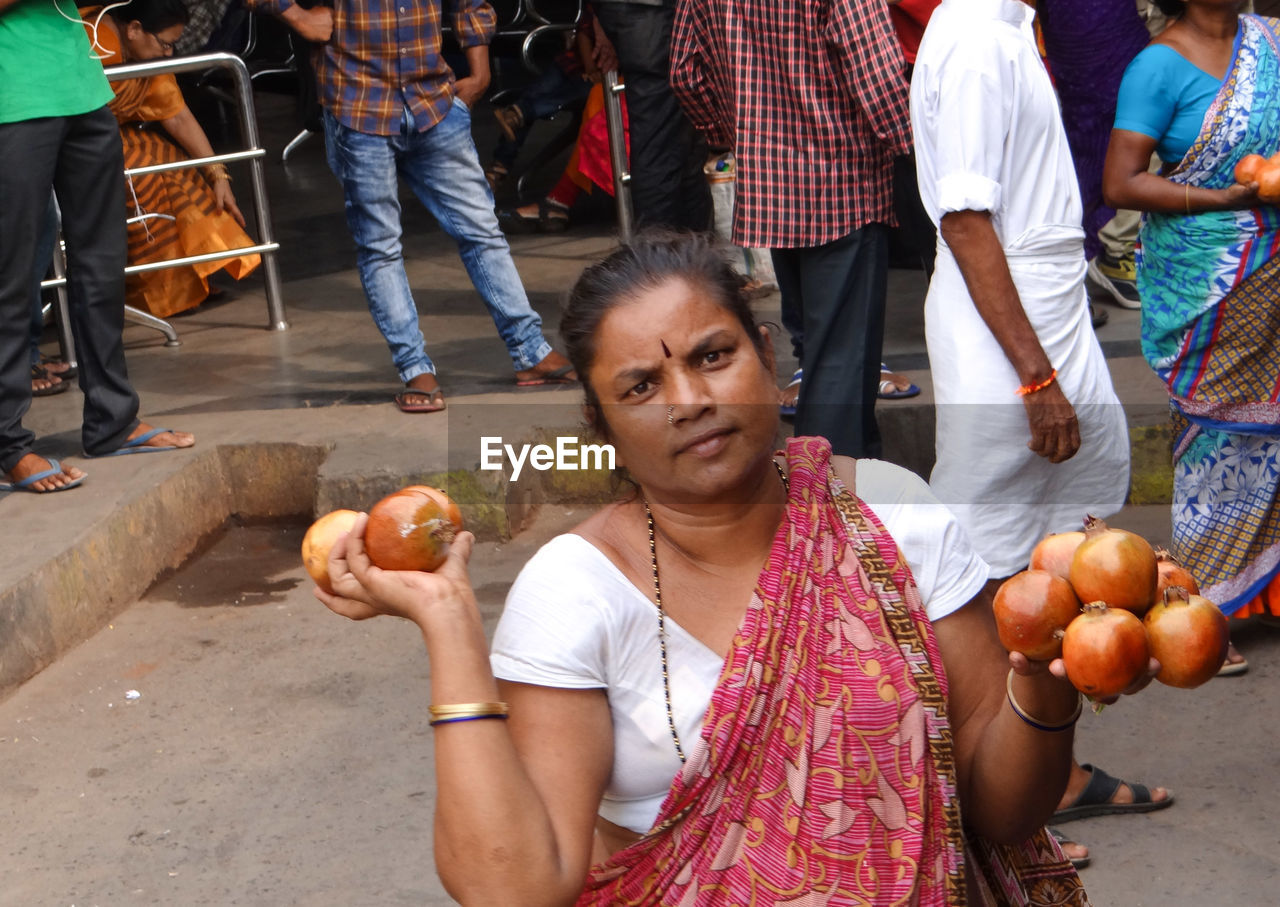 Woman holding fruits in market