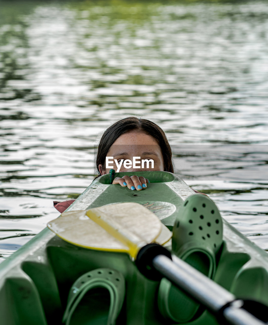 Portrait of woman holding a boat in lake