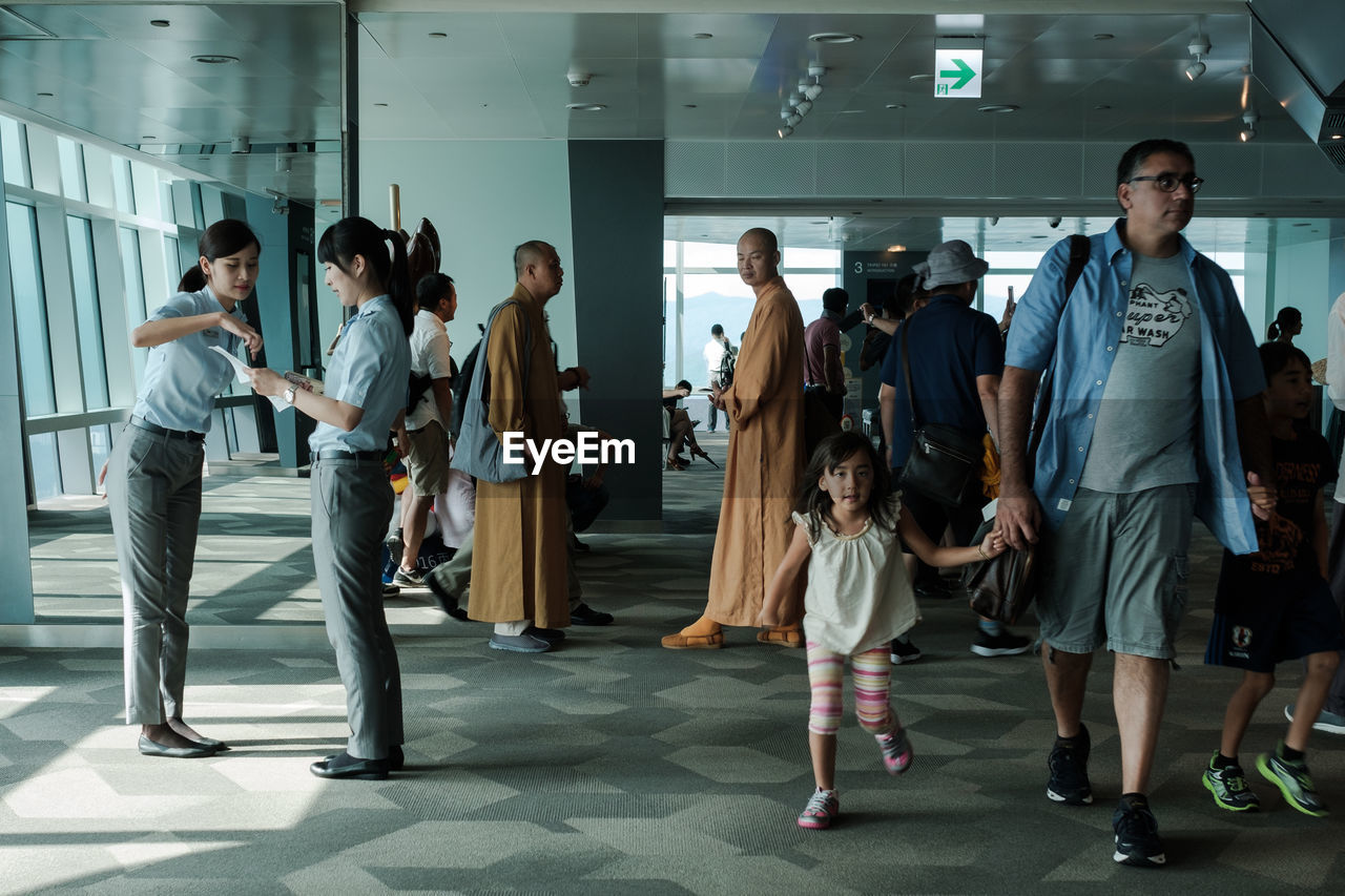 GROUP OF PEOPLE STANDING IN FRONT OF AN EMPTY