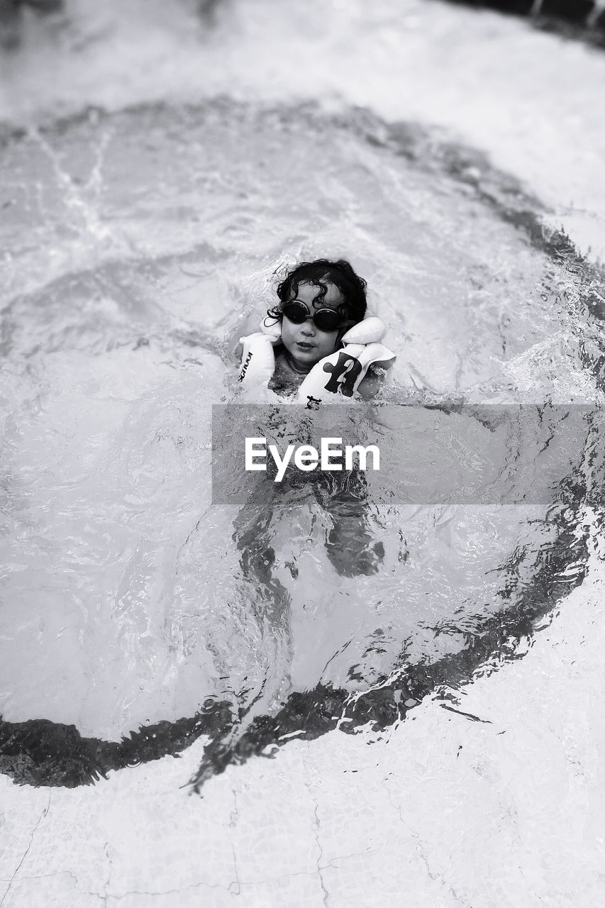 HIGH ANGLE VIEW PORTRAIT OF BOY IN SWIMMING POOL