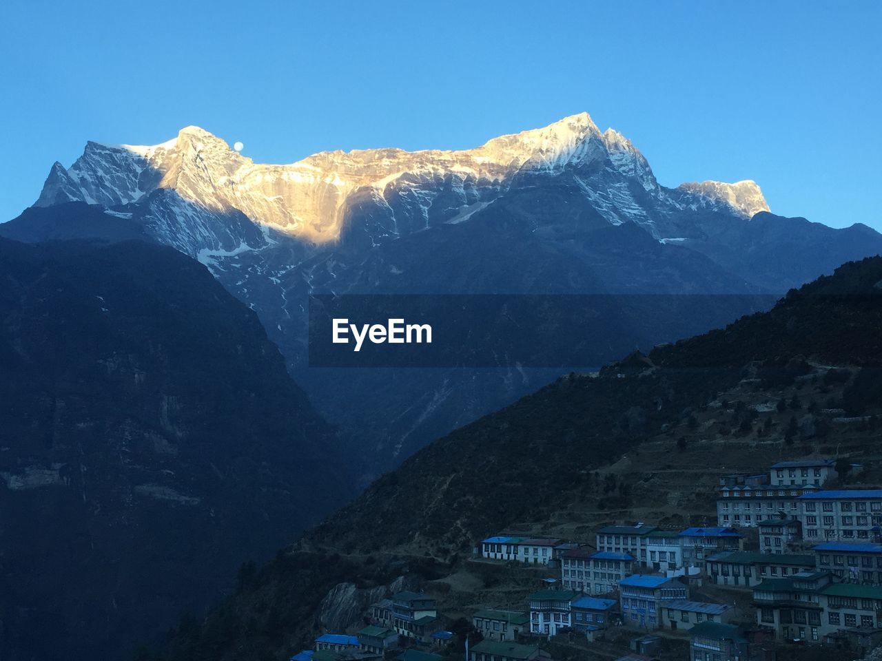 Scenic view of mountains against clear blue sky