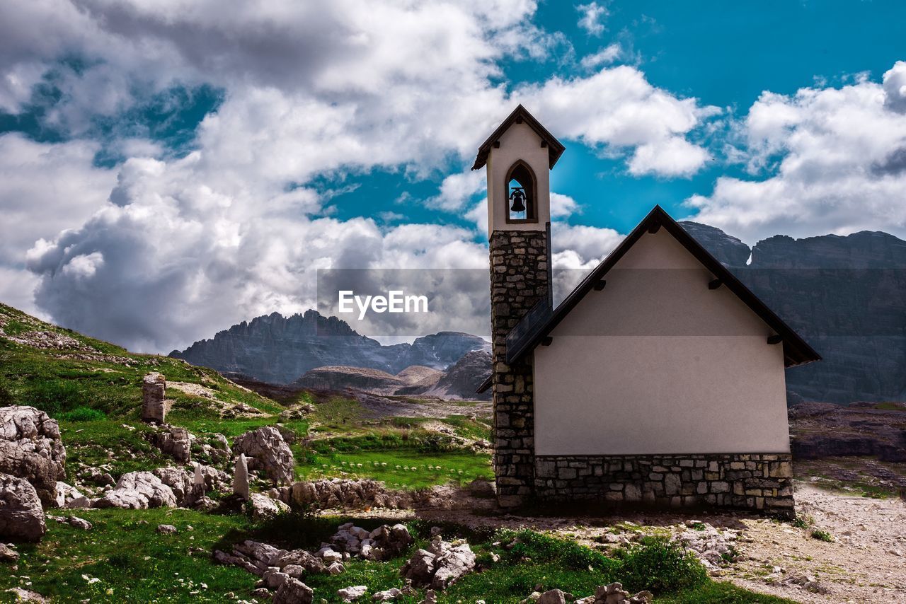 Exterior of building by mountains against sky