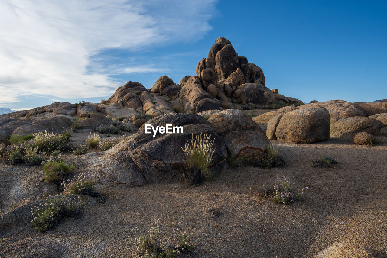 Rock formations on landscape against sky