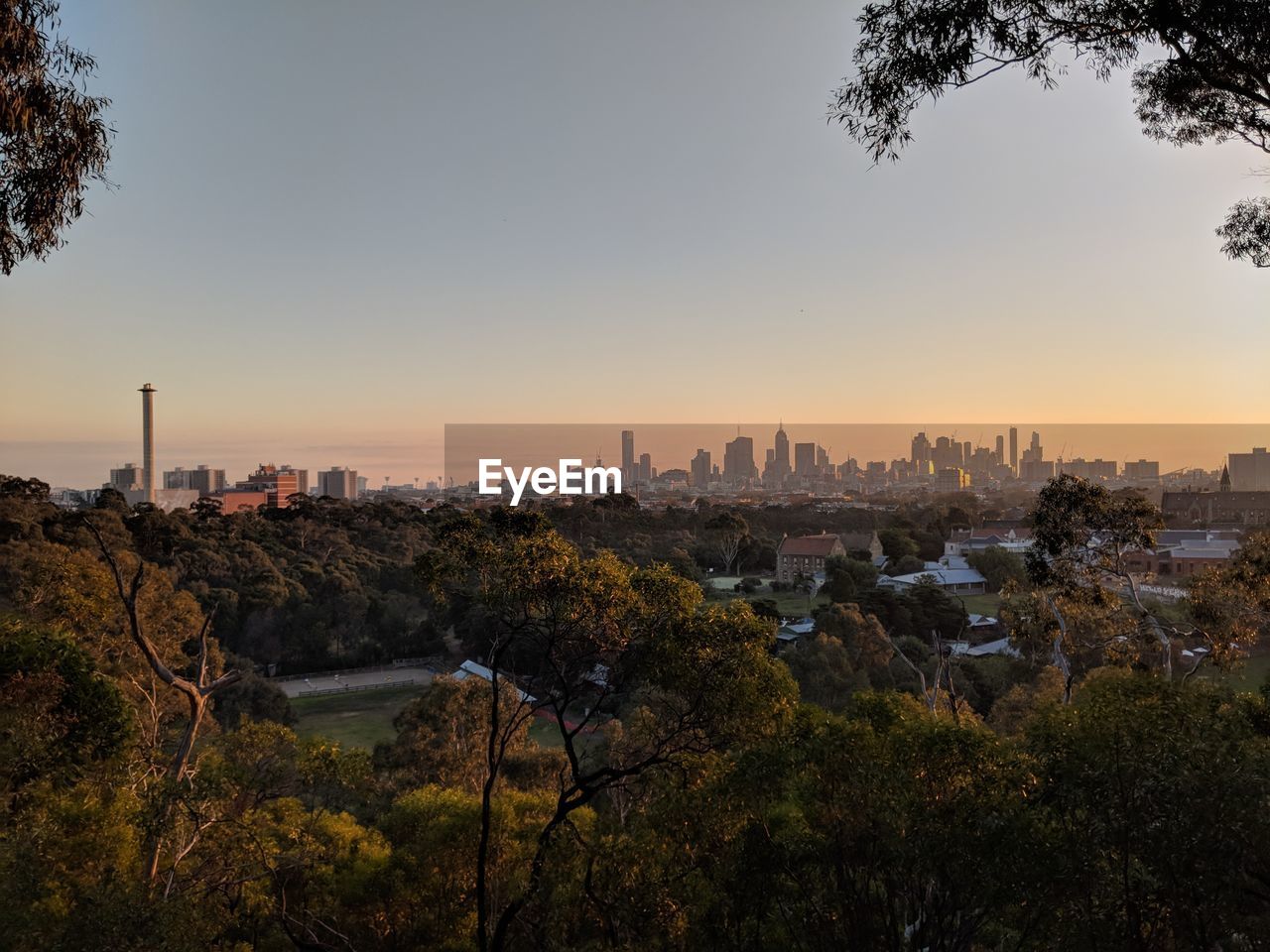 BUILDINGS IN CITY AGAINST SKY DURING SUNSET