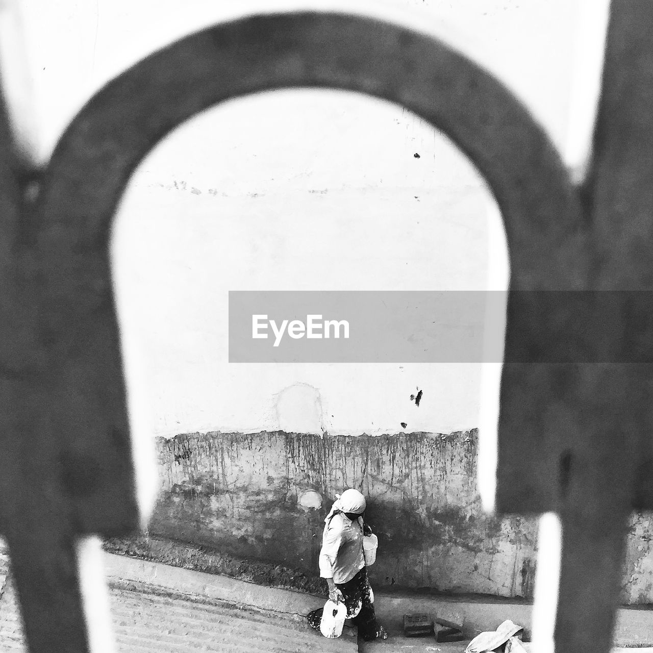 Labor walking by building seen through window